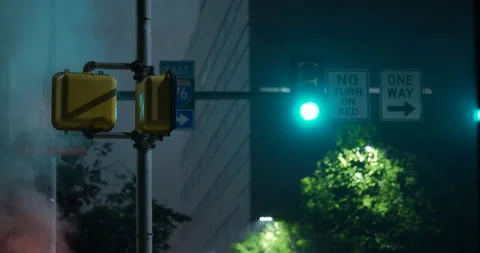 4K MEDIUM SHOT OF TRAFFIC LIGHT AT NIGHT WITH SMOKE OR STEAM Stock Footage 131108727