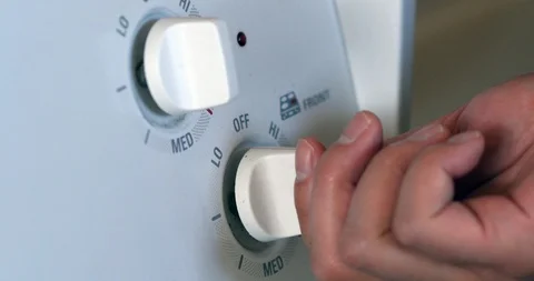 4k medium shot turn on stove dial switch Stock Footage 95452384
