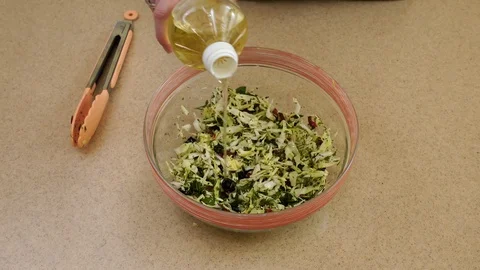 4K. Medium shot. Woman’s hands are dressing a salad Stock Footage 128329199