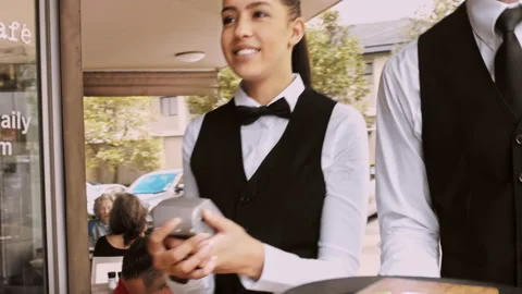 4k medium steadicam video of waiter and bill on a tray, walking to a customer in Stock Footage 201094633