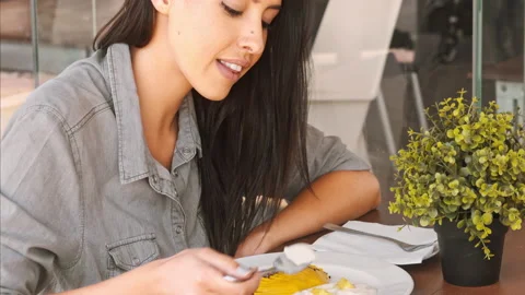 4k medium video of beautiful multiracial woman eating healthy organic breakfast Stock Footage 201095598