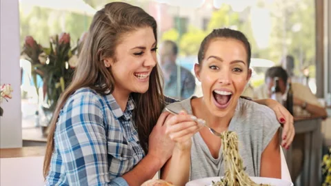 4k medium video of close in friendship women smiling,  while eating gourmet dish Video stock 201094321