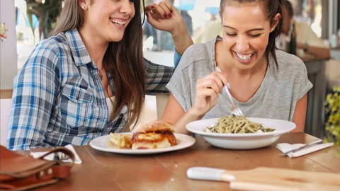 4k medium video of close in friendship women smiling, while eating gourmet dishe Stock Footage 201096914
