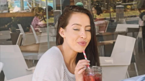 4k medium video of Latin young woman taking a break from study by drinking cold Stock Footage 201094787