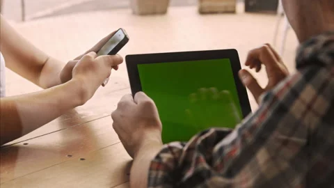 4k medium video of man holding a green screen tablet and using his fingers on to Video stock 201094270