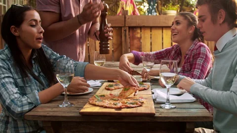 4k medium video of multicultural group of young friends enjoying a meal, food pi Stock Footage 201093996