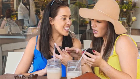 4k medium video of multicultural woman friends using smartphones and drinking ic Stock Footage 201097110