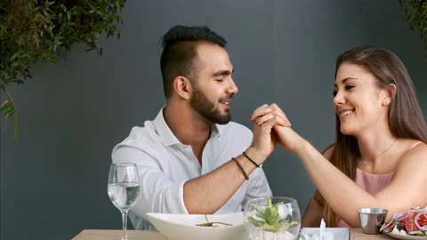 4k medium video of multiracial happy and romantic couple having dinner on date i 스톡 동영상 201094398