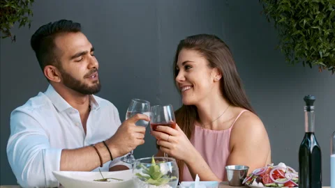 4k medium video of multiracial happy and romantic couple making a toast as its t Video stock 201096289