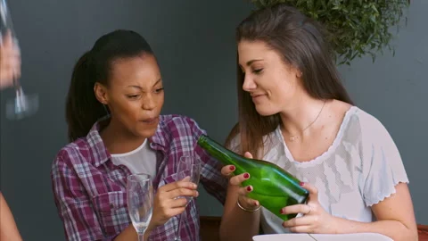 4k medium video of women, multicultural friends decanting champagne to toast fri Video stock 201095804