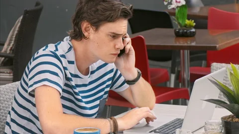 4k medium video of young and exited casual man answering call, while catching up Stock Footage 201095163