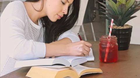 4k medium video of young and focused student working with text books and writing Stock Footage 201096793