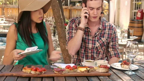 4k medium video of young casual man talking on smartphone at lunch wile in a gar Stock Footage 201094423