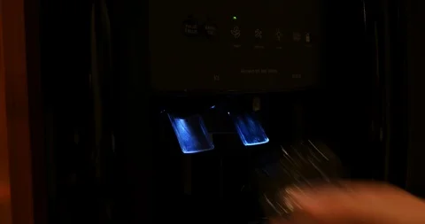 4K Medium wide shot getting ice and water from refrigerator Stock Footage 100094785