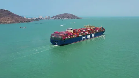 4k megacontainer cargo ship Hyundai Pride sailing out Vung Tau channel Stock Footage