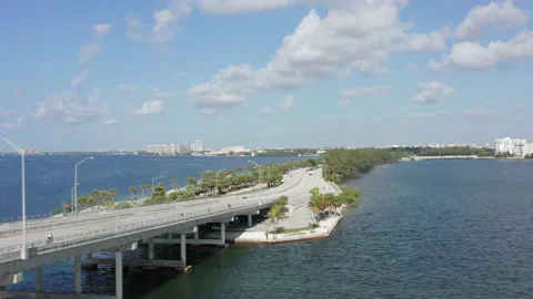 4K Miami highway along the seafront. Green city is seen in the distance 스톡 동영상 134574239