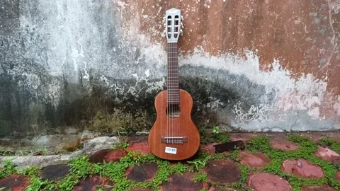 4K: Mini Guitar on Cement Background Stock Footage 207400403