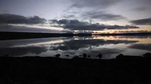 4k mirror reflections over the stenness loch with the hoy hills in Orkney Video stock 297768178