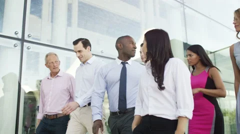 4K Mixed ethnicity business team walking together outside office building Stock Footage