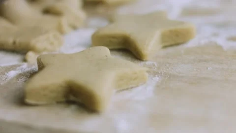 4K Mixed Raw Holiday Cookie Shapes and Dough Scraps on Parchment Stock Footage 342113438