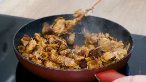 4K Mixing Fried Meat Stew with Onion in pan on stove. Close up Stock Footage 155339545