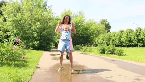4K. Mom and son 2 years old play in the park on a Sunny summer day Stock Footage 133904862