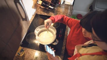4k Mom and Son Baking Cake, Watching Recipe on Smartphone Stock Footage 86089624