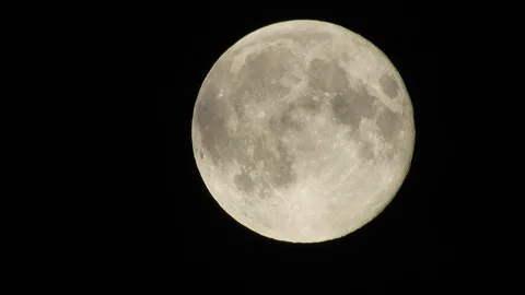 4k Moon in cloudy night sky close up video Stock Footage 93928561