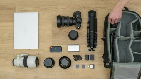4k motorized dolly timelapse of packing photography equipment into camera bag Stock Footage 132404976