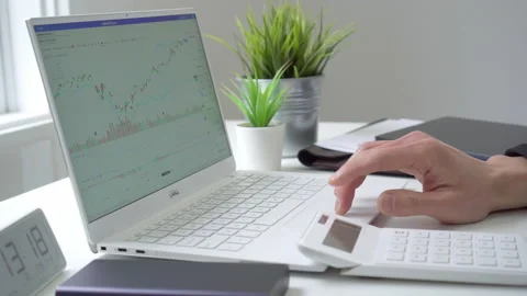 4k motorized jib shot of browsing stock market data online Stock Footage 134442398