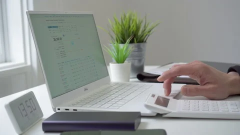 4k motorized jib shot of browsing stock market data online Stock Footage 134748972