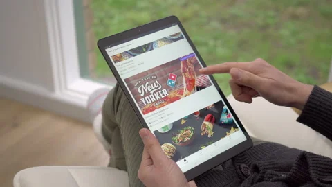 4k motorized jib shot of ordering takeaway delivery using Uber Eats app Stock Footage 134511337