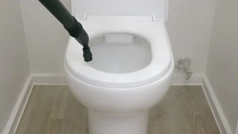 4k motorized tracking shot of sanitizing toilet bowl using steam cleaner Stock Footage 132328072