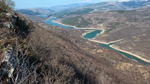 4K Mountain Cliff Overlook – Slow Pan of Winding Lake Video stock 331813333