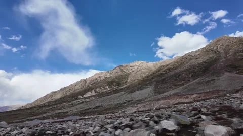 4K Mountain Serenity Side View  Green Meadows, Surrounded by Towering Rocky  Stock Footage 288322427
