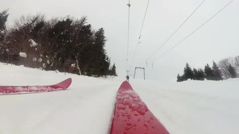 4k. Mountain skiing with red ski .Ski lift .Pov clip Stockbeeldmateriaal 90932654