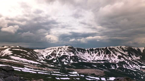 4K. Mountain in snow and sky in clouds. Time lapse without birds. Stockbeeldmateriaal 64447232