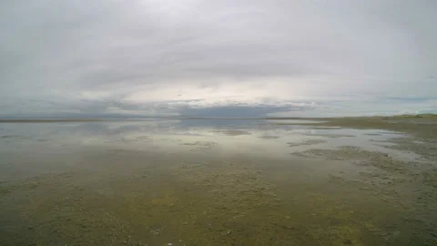 4K. Movement of the clouds over the salted lake Durgun Nuur, Mongolia. Ultra  Stock Footage 107023363