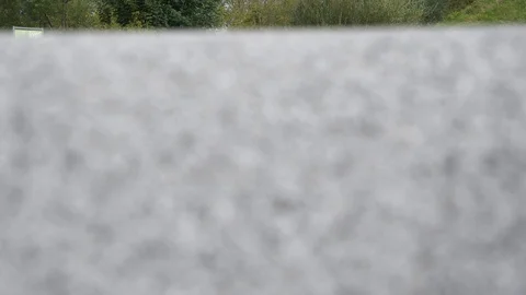 4K Moving camera focus from foreground to young woman running with skateboard Stock Footage 118929363