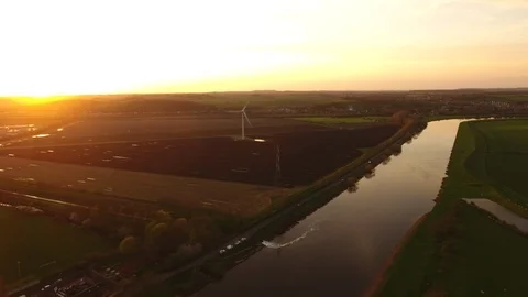 4k moving drone shot of a river within a british series of farmers fields Stock Footage 90796126