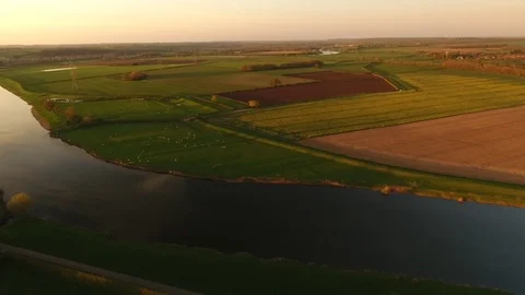 4k moving drone shot of a river within a series of farmers fields, summer scene Stock Footage 90796769