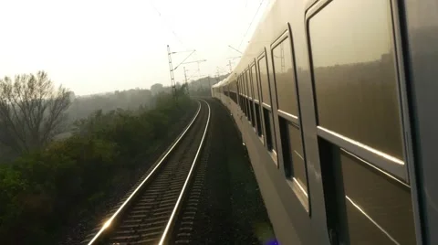 4K moving train in evening sun and reflecting tracks Stock-Footage 43205300