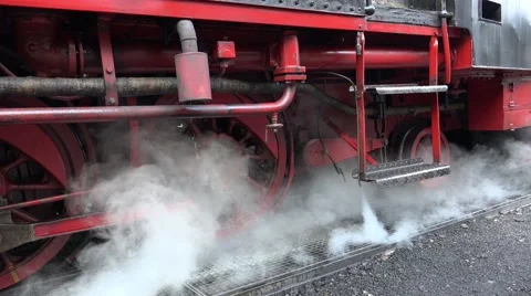 4k Much steam below a classic steam locomotive standing at station Stock Footage 42548133