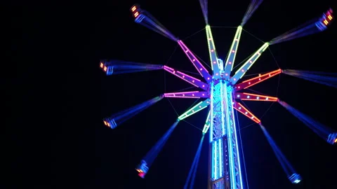4K Multi-coloured merry-go-round on background of black sky rotating fast Stock-Footage 167009146