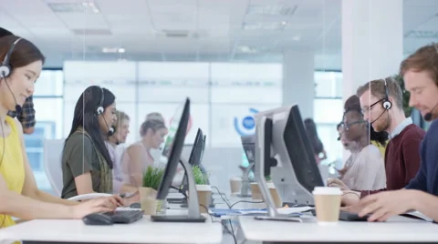 4K Multiracial telesales team talking to customers in busy call center Stock Footage