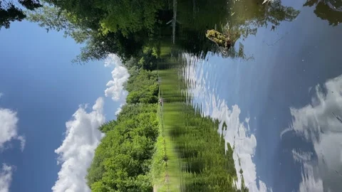 4k Narrow river between green trees with blue sky and clouds. Stock Footage 157925389