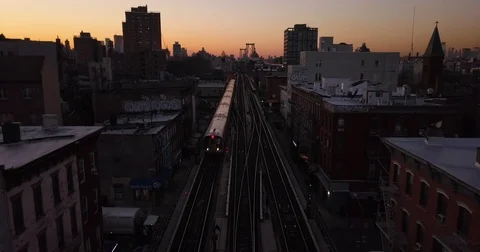 4k New York City J train on elevated track drone shot during sunset in 4k  Stock Footage