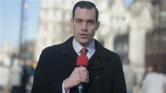 4K News Reporter Doing Live Piece To Camera In Busy City Area Stock Footage 4K News Reporter Doing Live Piece To Camera In Busy City Area Stock Footage