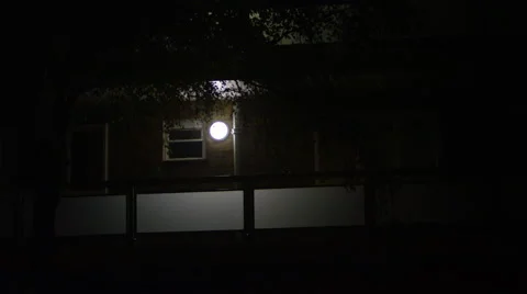 4K Night exterior view, windows of a London block of flats with security light Stock Footage 54777555