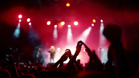4K Night rock concert front row crowd cheering hands in air Stock Footage